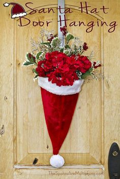 a santa hat door hanger with flowers in it