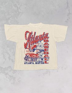 Show the love for your favorite team in this Atlanta Baseball oversized tshirt that is inspired by vintage 90s M L B tshirts! - Features Atlanta across the top & baseball down the side with a baseball player and baseball design and 1871 all in a navy and red ink- Screen print transfer that is heat pressed onto each tshirt- Tshirt is a super soft vintage wash that gets softer after each wash- Oversized fit- Sizing translation: XS/S = L , S/M = XL , L/XL = 2XL , 2XL/3XL = 3XL , 4XL/5XL = 4XL- Size Graphic Baseball Tee, The Stadium Tour 2022 Shirt, Cheap Screen Print Tops For Sports Events, Retro Baseball Shirt, Sports Team Merch Ideas, Sports Team Tshirt Design, Vintage Fraternity Shirts, Vintage College Tshirt, Vintage Merch Design