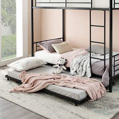 a black bunk bed sitting on top of a rug