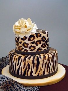 the cake is decorated with zebra print and a white rose on top, as well as an instagram post