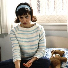 a woman sitting in front of a laptop computer