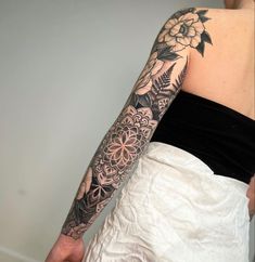 a woman with a flower tattoo on her arm