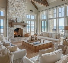 a living room filled with furniture and a fire place in front of a stone fireplace