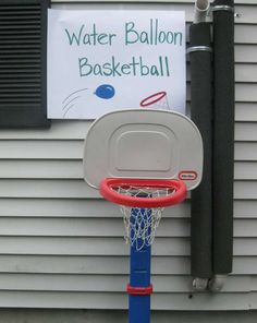 a basketball hoop attached to the side of a house with a water balloon basket on it