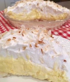 a piece of pie sitting on top of a white plate next to a red and white checkered table cloth