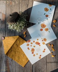 three different colored papers on top of a wooden table