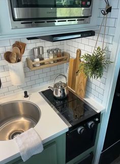 a kitchen with a sink, stove and microwave