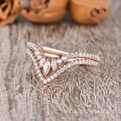 a close up of a ring on a table with other jewelry items in the background