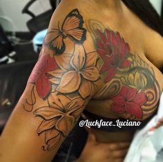 the back of a woman's arm with flowers and butterflies on it