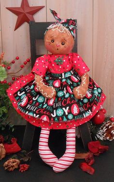 a teddy bear sitting on top of a wooden chair next to christmas decorations and ornaments