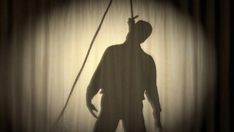 the shadow of a man standing in front of a curtain with a pole attached to it