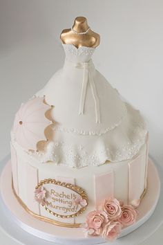 there is a wedding cake that looks like it has a dress and umbrella on top