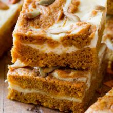 slices of carrot cake with cream cheese frosting and pumpkin seeds