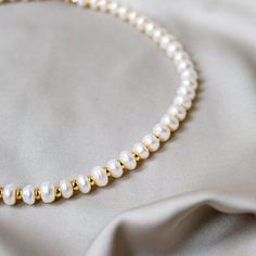 Pearl Necklace -  Elegant Classic Pearl Necklace - Layered Necklace - Wedding Necklace Item Details: ⭐ This necklace is 40cm long. You can request your own desired length if this is not the length you like.  ⭐ The necklace is made with coin freshwater pearls and 18k gold plated gold beads. ⭐ Freshwater pearls are also a natural product, and the shape and colour vary slightly. ⭐ Product colour may slightly vary due to photographic lighting sources or your monitor settings. Please take that into c Dainty Beaded Necklaces With Round Beads For Wedding, Elegant Pearl Necklace For Birthdays, Adjustable Round Beads Pearl Necklace For Anniversary, Adjustable Pearl Necklace With Round Beads For Anniversary, Adjustable Pearl White Pearl Necklace For Anniversary, Adjustable Pearl White Necklace For Anniversary, Handmade Bridal Necklace With Round Beads For Anniversary, Pearl White Necklace For Anniversary And Mother's Day, Classic Necklace With Spacer Beads For Gift