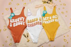 three swimsuits that say happy birthday, tired and get engaged