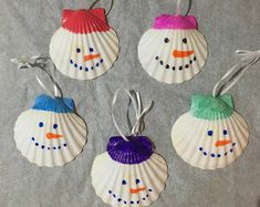 four seashell ornaments with snowmen on them