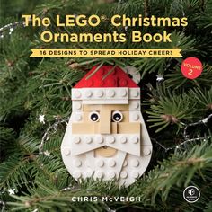 the lego christmas ornament book is shown in front of a pine tree with a santa