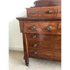 a wooden dresser with several drawers and knobs