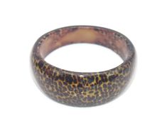 Vintage black and brown animal print 8 inch Lucite bracelet. DETAILS: ☼ Approximately 8 inches. ☼ Approximately 38 grams total weight. ☼ ☼ ☼ ☼ ☼ ☼ ☼ ☼ ☼ ☼ ☼ ☼ ☼ ☼ ☼ ☼ ☼ ☼ ☼ ☼ ☼ PLEASE NOTE: ☼ Different items on SALE everyday! Check back often to take advantage of these bargains! ☼ FREE DOMESTIC SHIPPING on purchases of $35 or more. Combined shipping is still available to domestic and international locations. ☼ This shop is happy to accept exchanges, returns for store credit. Cash returns are onl Brown Bangle Bracelet For Fashion, Handmade Brown Round Bangle, Brown Adjustable Bangle, Adjustable Brown Round Bangle, Adjustable Round Brown Bangle, Lucite Bracelets, Classic Bracelets, Vintage Monet, Blue Tigers Eye