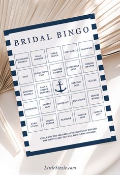 the bridal bingo game is sitting on top of a table next to an umbrella