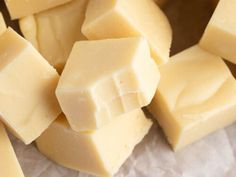 several pieces of butter sitting on top of wax paper