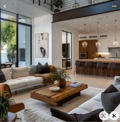 a living room filled with furniture next to a kitchen and an open concept floor plan