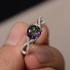 This is a gorgeous handmade creation. Its beauty is its simplicity & Elegance. The 7*7 mm round shape faceted real Mystic Topaz is crafted in solid sterling silver and with rhodium plated. All item is sent in a beautiful gift box If you have any idea of design your ring,pls contact me directly. You can realize more lovely stuff clicking the link https://www.etsy.com/shop/knightjewelry?refshopsection_shophome_leftnav Please leave the correct address and you phone number for delivering success Rainbow Topaz Ring, Topaz Rings, November Birthstone Ring, Swiss Blue Topaz Ring, Rainbow Topaz, Mystic Topaz Ring, Rings Sterling Silver, Rainbow Gemstones, Topaz Engagement Ring