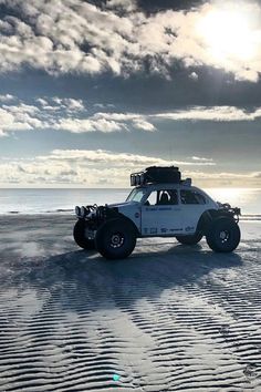 an off - road vehicle is parked on the beach