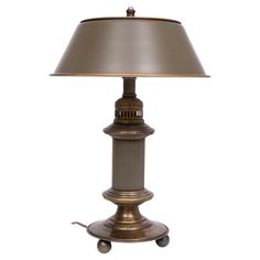 a lamp that is sitting on top of a table with a light shade over it