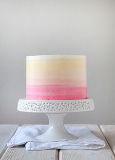 a white cake with pink and yellow frosting