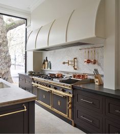 a kitchen with an oven, stove and counter top next to a large glass window