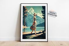 there is a poster on the wall with a woman walking in front of water and mountains