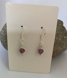 These are beautiful Tourmaline Dangle Earrings with Sterling Silver Hooks.  Tourmaline is one of the birthstones for October and the name 'Tourmaline' comes from the Sri Lanken words Turi Mali which means 'unknown gemstones of mixed colours'. These gemstone beads are are beautiful mix of pinks and purples with the occasional shades of grey. I aim to keep the beads looking similar in shade and colour, although each bead is unique. Tourmaline is said to create a shield around a person to prevent any negative or unwelcome energies from entering These earrings are made with  6mm Tourmaline gemstone beads which are wrapped with silver plated non tarnish wire. This helps to frame the beads and brings out the beautiful colours of the tourmaline. The beads are attached to 925 sterling silver ear h Nickel Free Sterling Silver Earrings For Birthday, Nickel-free Sterling Silver Earrings For Birthday, Nickel Free Drop Earrings For Birthday, Silver Hypoallergenic Earrings For Birthday Gift, Pink Birthstone Drop Earrings, Handmade Sterling Silver Earrings For Birthday, Birthstone Crystal Dangle Earrings As Gift, Birthstone Dangle Crystal Earrings For Gift, Nickel-free Drop Earrings For Birthday