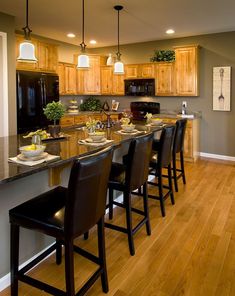 a kitchen filled with lots of counter top space next to a dining room table and chairs