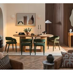 a dining room table surrounded by green chairs and wooden tables with vases on them