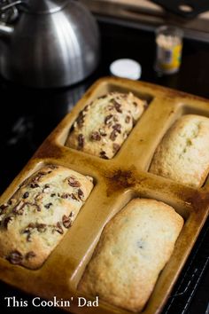 a pan filled with baked goods sitting on top of a stove