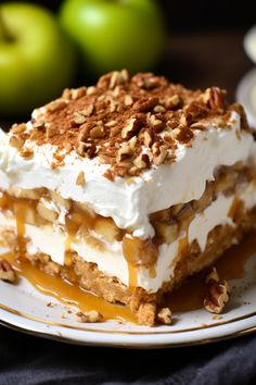 a piece of cake on a plate with apples in the background