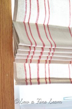 red and white striped curtains hanging on a window