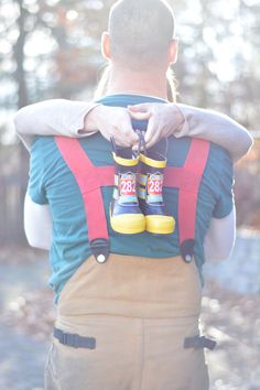 a man carrying a child in his back