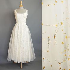 Our star gazer dress is made from layers of soft floaty tulle which features a metallic gold celestial pattern that shimmers in the light. The square scoop bodice and ballerina length circle skirt offer an understated nod to the 1950s while maintaining the flattering shape that our customers love. The tulle is overlaid on to a cotton poplin base for a dress that is light and comfortable to wear all day. Fastening at the back with a concealed zip, the dress is fully lined with cotton on the bodic Wedding Dress Ankle Length, Celestial Wedding Dress, Dig For Victory, Dress Ankle Length, Celestial Pattern, Above Elbow, Celestial Wedding, Long Torso, Circle Skirt