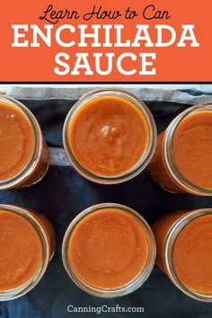 four jars filled with enchilada sauce on top of a blue table cloth