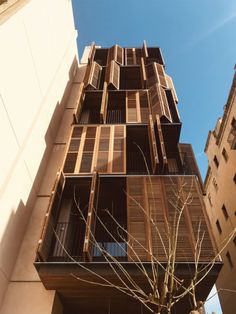 an apartment building with wooden balconies on the side