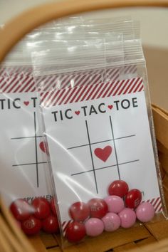 two bags of tic tac toe candy sitting on top of a basket