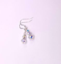 These elegant Swarovski crystal earrings will pick up the colors and accentuate any outfit. AB crystal clear bicones and rondelles increase in size gradually from the sterling silver French hook ball earwire. Perfect for weddings or a night out. The earrings are about 3/4 inch long and come nestled comfortably in a white cardboard box. Handmade by me in the USA. NA-817-0624-1111 Sterling Silver Round Bead Crystal Earrings, Adjustable Sterling Silver Beaded Crystal Earrings, Hypoallergenic Sterling Silver Crystal Earrings For Party, Adjustable Crystal Drop Earrings, Iridescent Crystal Drop Earrings, Hypoallergenic Crystal Party Earrings, Carmel Ca, Aurora Borealis Crystal, Box Handmade