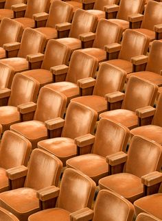 rows of brown plastic chairs sitting next to each other