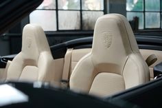 the interior of a sports car with beige leather and tan stitching on the seats