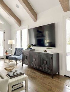 a large flat screen tv mounted to the side of a wall in a living room