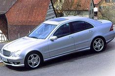 a silver car parked in front of a house