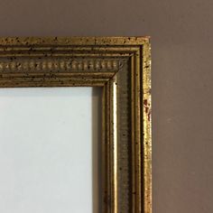 an old gold framed mirror on the wall