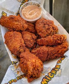 fried chicken is served with dipping sauce on the side